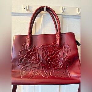 Patricia Nash red leather handbag with a floral embossed design